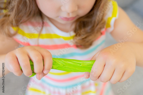 Little girl holding green slime photo