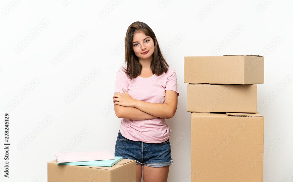 Young girl moving in new home among boxes laughing Young girl moving in new home among boxes laughing