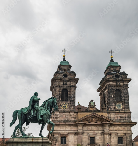 Monument Kaiser Wilhelm I near St. Egidien old baroque Church with bell towers and a large bronze crucifix, Old Town of Nurnberg, Germany