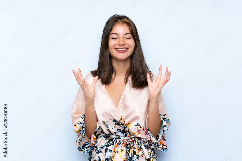 Caucasian girl with kimono over isolated blue background laughing Caucasian girl with kimono over isolated blue background laughing