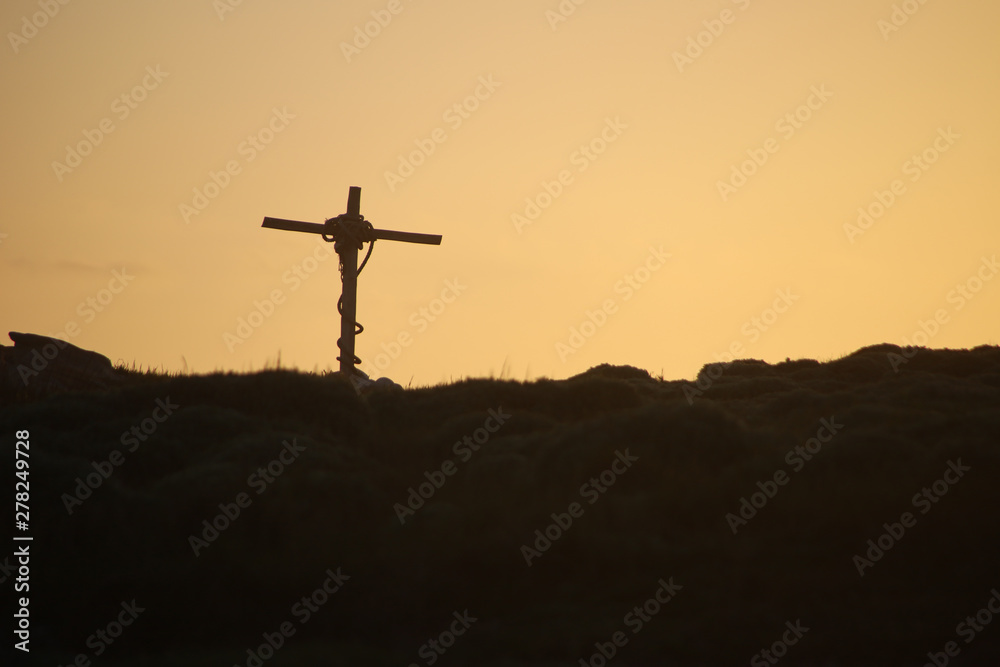 Cross and the setting sun