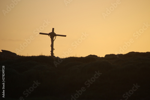 Cross and the setting sun