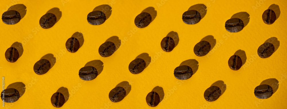 the pattern of coffee beans on colored background