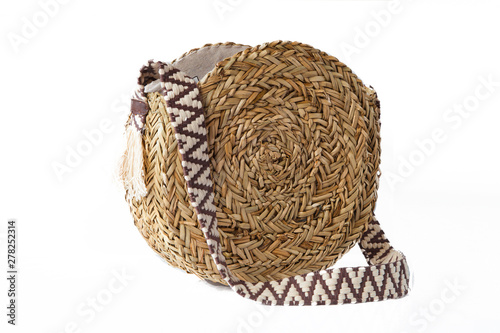 Round straw bag isolated on white background. Trendy wicker bag. 