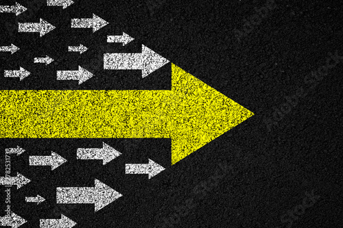 Leadership concept. Arrows on asphalt background.