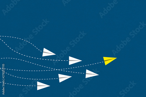 Leadership and competition concept, with yellow paper plane leading among white.