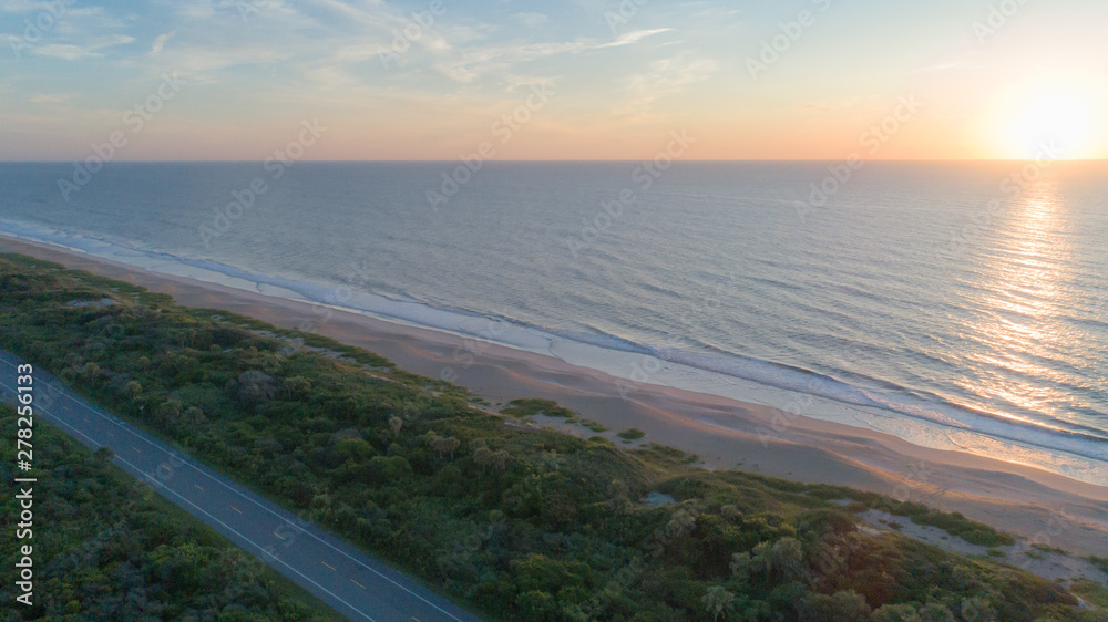 Beautiful sunrise aerial of road and beach