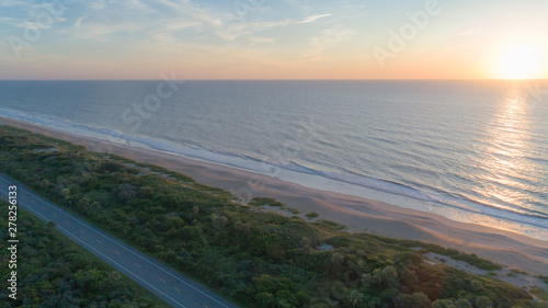 Beautiful sunrise aerial of road and beach