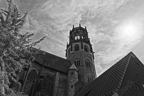 Tower of St. Ludgeri catholic church against sky in black and white