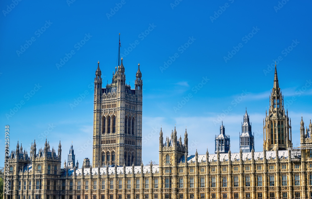British Parliament along the River Thames on a sunny day in London, UK. British Parliament along the River Thames on a sunny day in London, UK.