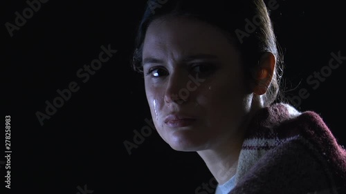 Young woman crying hard, feeling sorrow and hopeless after divorce, closeup