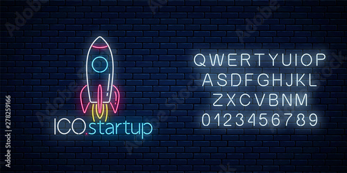 Glowing neon sign of ICO project startup with alphabet. Business fast start symbol as a flying rocket in neon style
