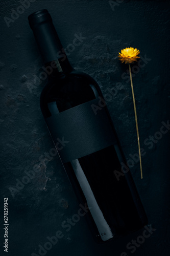 Red wine bottle mockup on stone. Black label photo