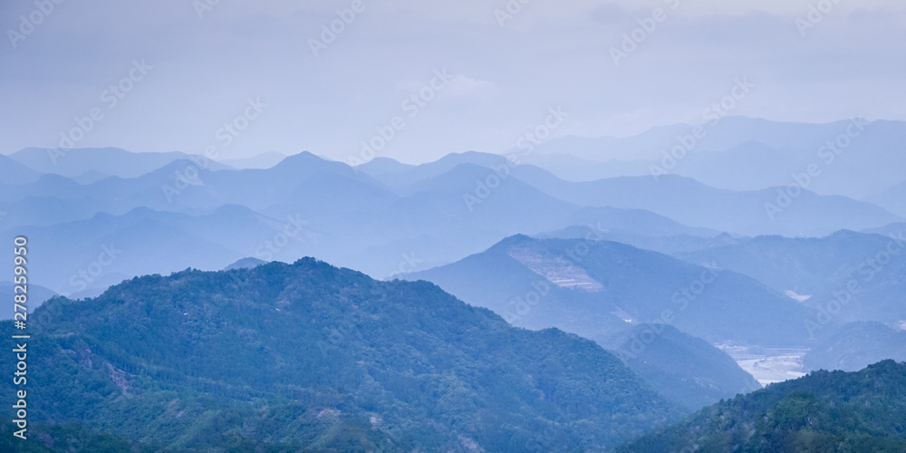 Fototapeta premium Rolling mountains in Hongu area on the Kumano Kodo trail. Kumano Kodo is a series of ancient pilgrimage routes that crisscross the Kii Hanto, the largest peninsula of Japan