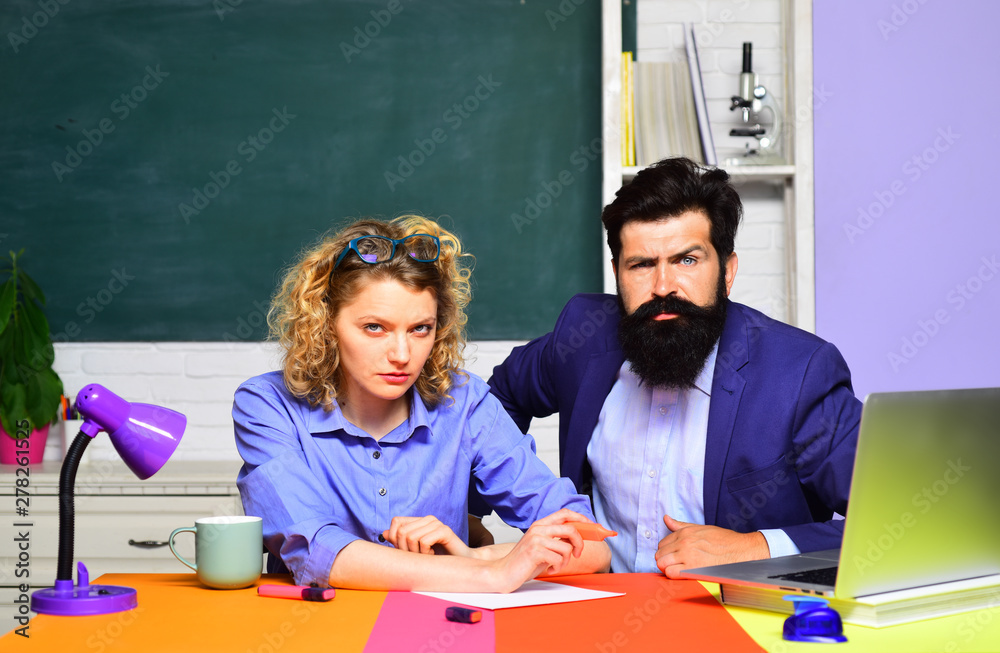 Back to school. School job. Serious male and female teachers in auditorium. World teachers day. Students studying in classroom. Young serious students. School students. University students at college.