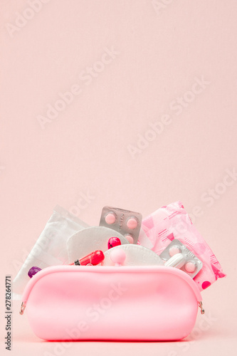 Women intimate hygiene products - sanitary pads and tampons on pink background, copy space. Menstrual period concept. Top view, flat lay, copy space