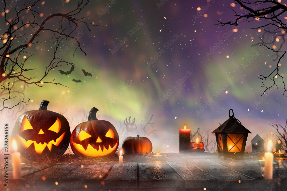 Halloween pumpkins on dark spooky forest with blue fog in background. - obrazy, fototapety, plakaty 
