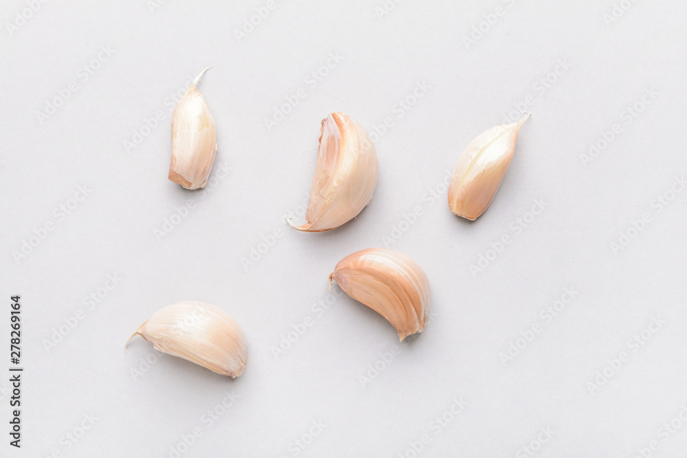 Garlic cloves on light background