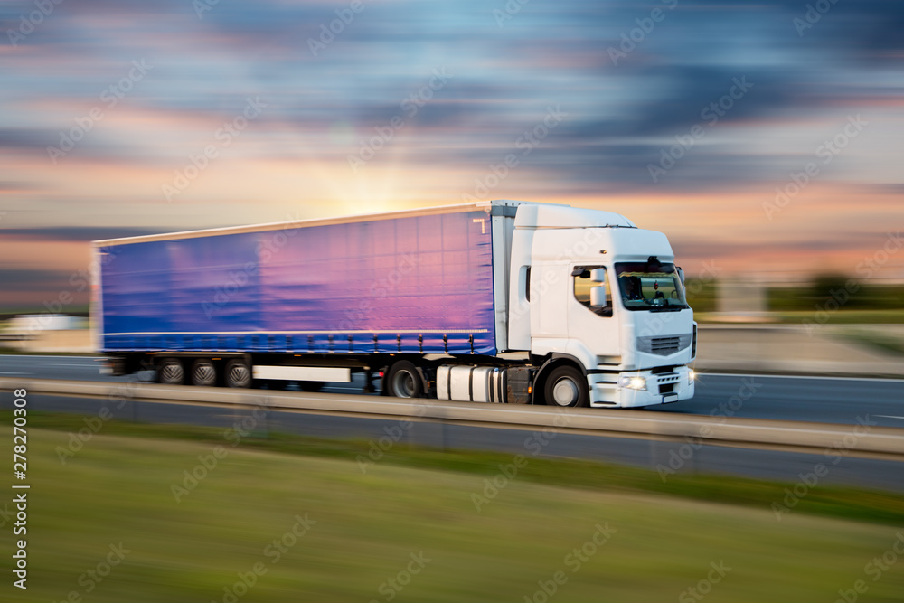 Truck with container on highway, cargo transportation concept. Shaving effect.