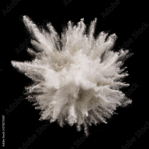 White powder explosion on black background. Freeze motion.