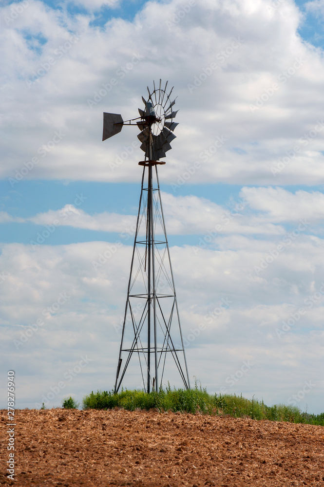 Old Farm Style Water Pumping Windmill. Still seen throughout the rural farming areas of the west some these old school farm implements are still in use.