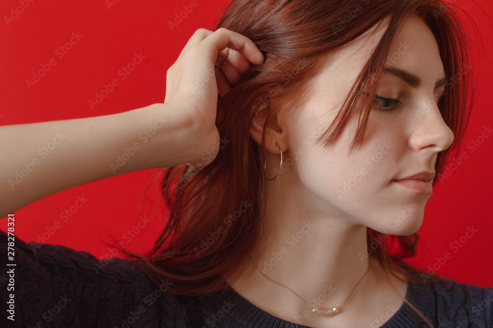Dangerously beautiful. Attractive young woman with a flower while standing against red background. Woman with rose Dangerously beautiful. Attractive young woman with a flower while standing against red background. Woman with rose