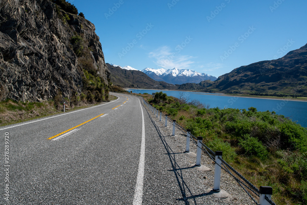 the highway winding its way around the shore of Lake Wanaka the highway winding its way around the shore of Lake Wanaka
