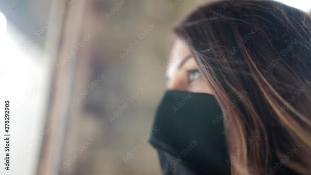 CU Beautiful masked woman gazing out of a window with incredibly beautiful and engaging eyes CU Beautiful masked woman gazing out of a window with incredibly beautiful and engaging eyes