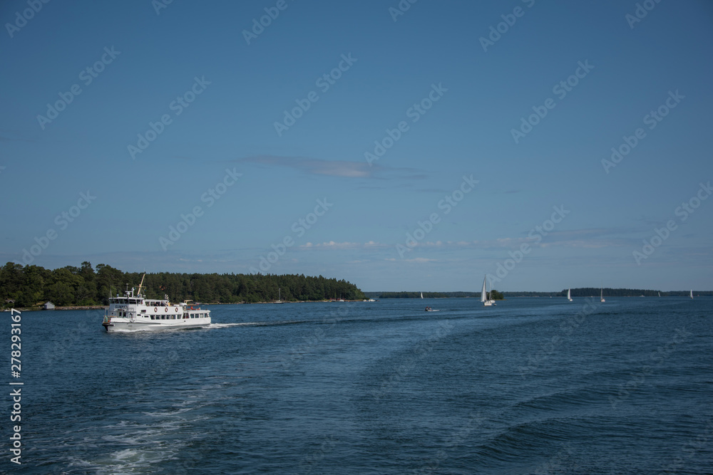 Commuting boats in the Stockholm northen archipelago a sunny summer day at the island Furusund and Yxlan