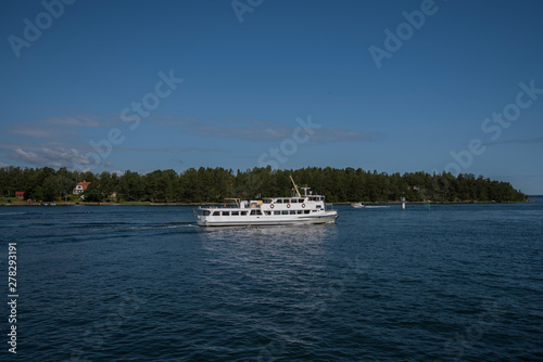 Commuting boats in the Stockholm northen archipelago a sunny summer day at the island Furusund and Yxlan photo