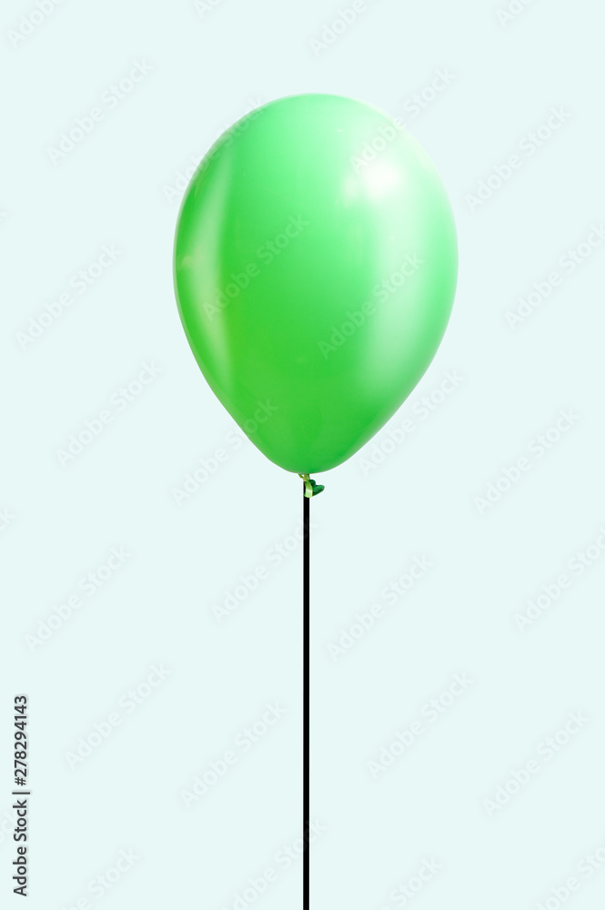 Green balloon isolated over green background, lightness, easiness concept, minimalism Green balloon isolated over green background, lightness, easiness concept, minimalism