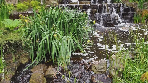 Slow Motion Of A Beautiful Waterfall Going Backwards At Regent's Park In The City Of London In England, United Kingdom - Tilt Up Shot - 4K 30fps photo