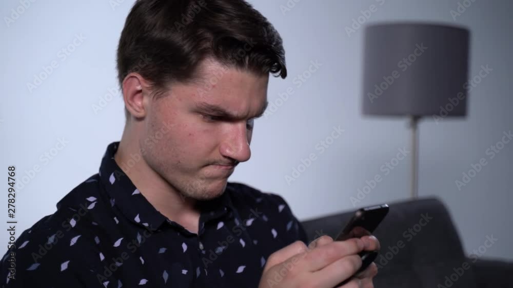 Caucasian Man on Phone in Apartment Living Room Angrily Texting Caucasian Man on Phone in Apartment Living Room Angrily Texting