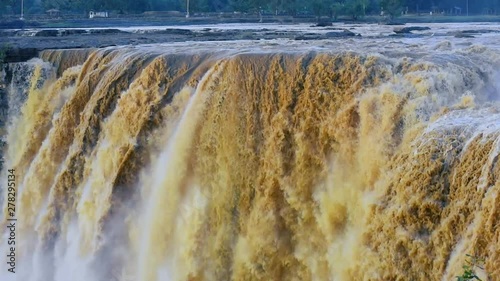 Large water volume flowing over beautiful Chitrakote Falls, Chhattisgarh, closeup photo