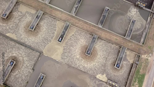 Overhead shot of rows of aerators at a wastewater treatment facility treating sewage and human waste. photo