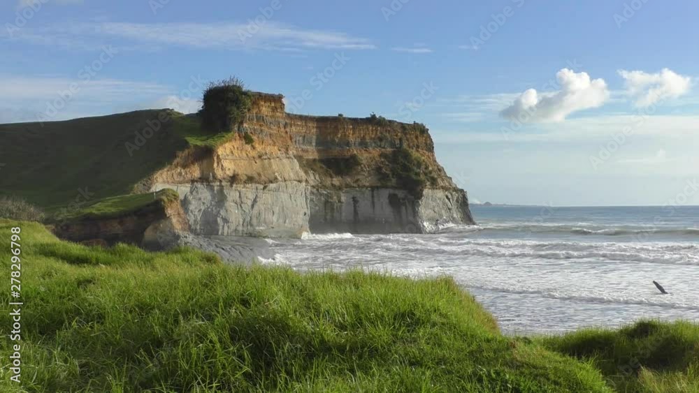 Remote seascape on eroded cliff edge on sunny day. WIDE. Remote seascape on eroded cliff edge on sunny day. WIDE.