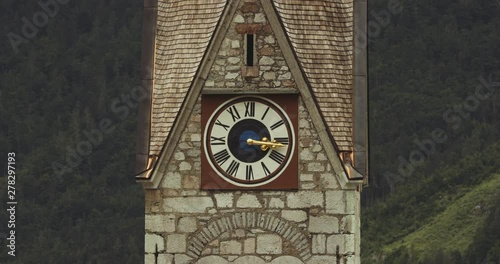 Close up view of the clock on the Catholic Parish Church in Hallstatt. Austria. photo