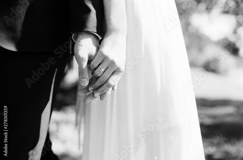 Bride and groom holding hands photo