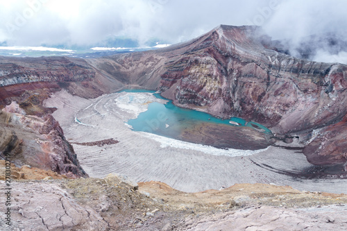 Crater of Gorely volcano crater with a lake, with ice, Kamchatka, Russia photo