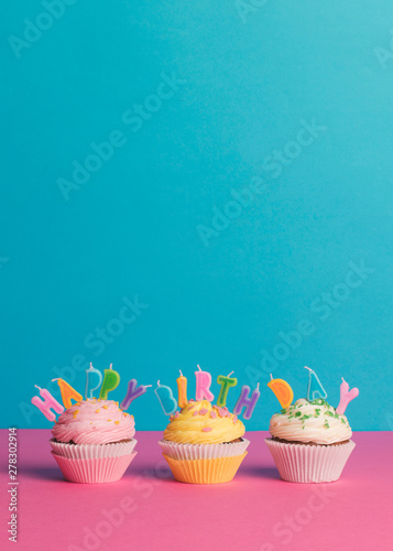 Cupcake with birthday candle on a blue background photo