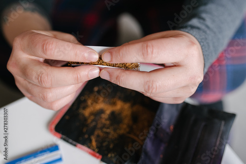 Anonymous female rolling domestic tabacco photo