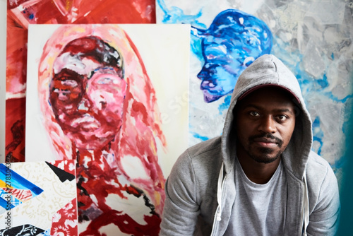 An artist portrait with artwork at the studio. photo