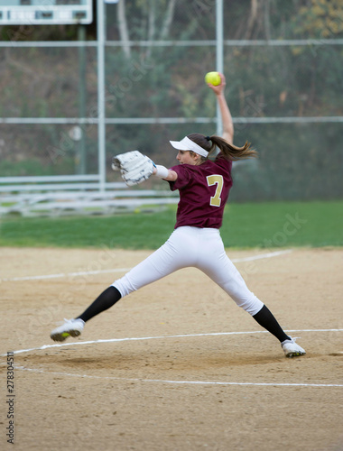 Female softball player throwing a fast pitch
