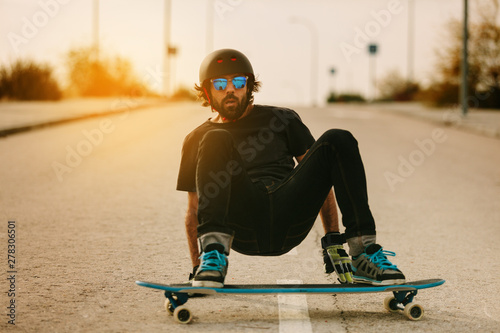 Young Man Longboarding in the Street photo