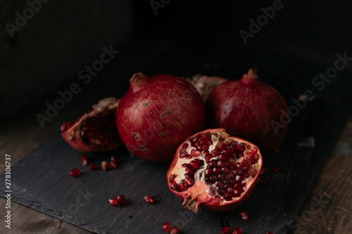 Fresh Pomegranate on slate in a dark moody kitchen