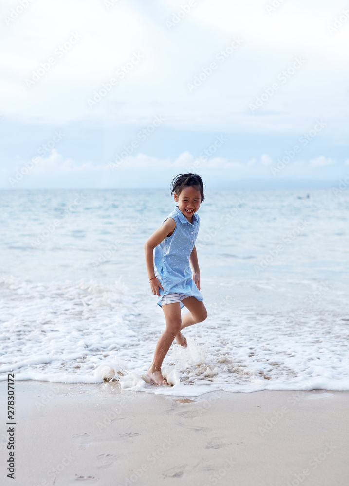Asian little girl playing excited at the seaside Asian little girl playing excited at the seaside