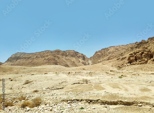Desert landscape with rocks  hills and mountains