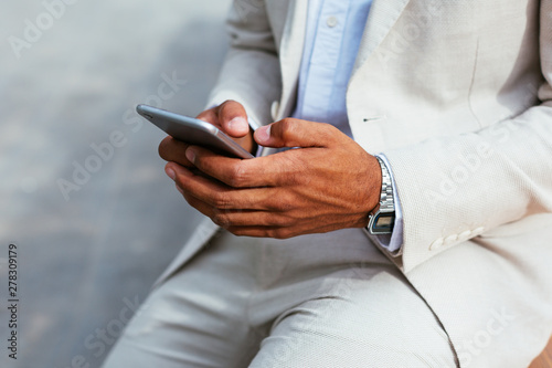 Businessman using his phone.