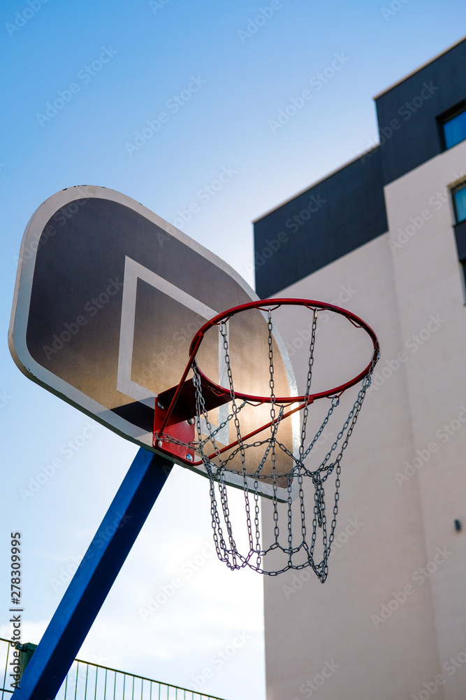 basketball ring on the background of the city and buildings, blue sky basketball ring on the background of the city and buildings, blue sky