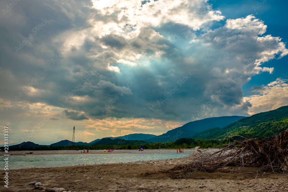 Storm over Tagliamento river in an hot summer day